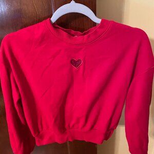 Red H & M sweatshirt with transparent heart decoration